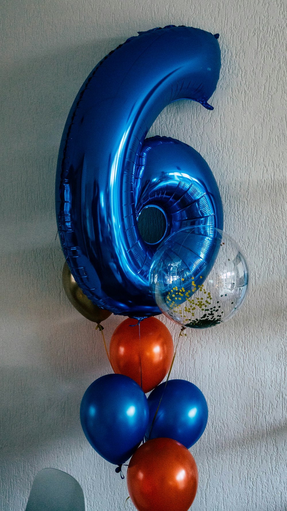 a number six balloon hanging from a wall
