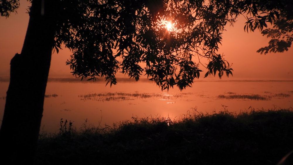 the sun is setting over a body of water