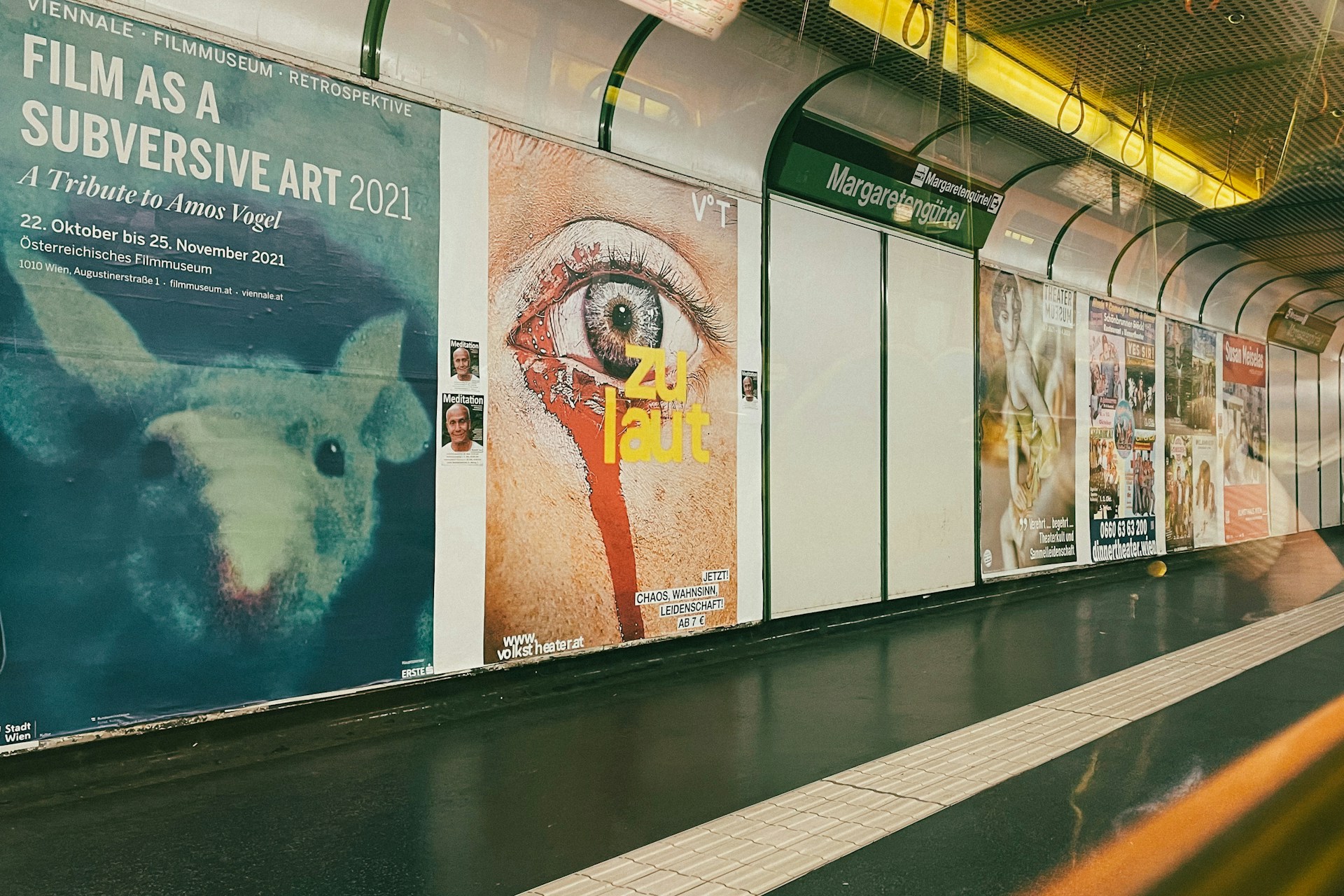 a subway train with posters on the side of it