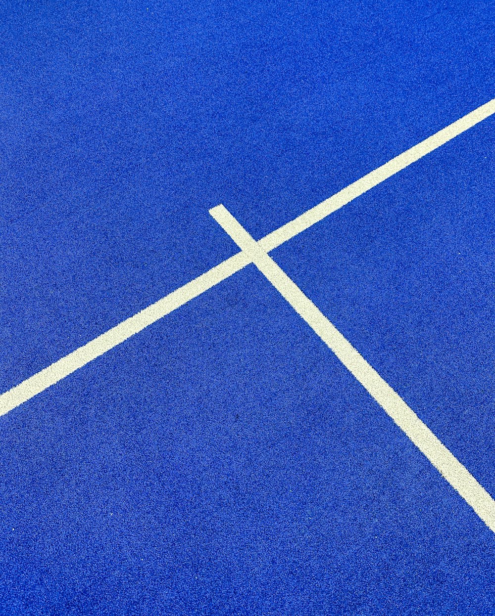 a blue tennis court with white lines on it