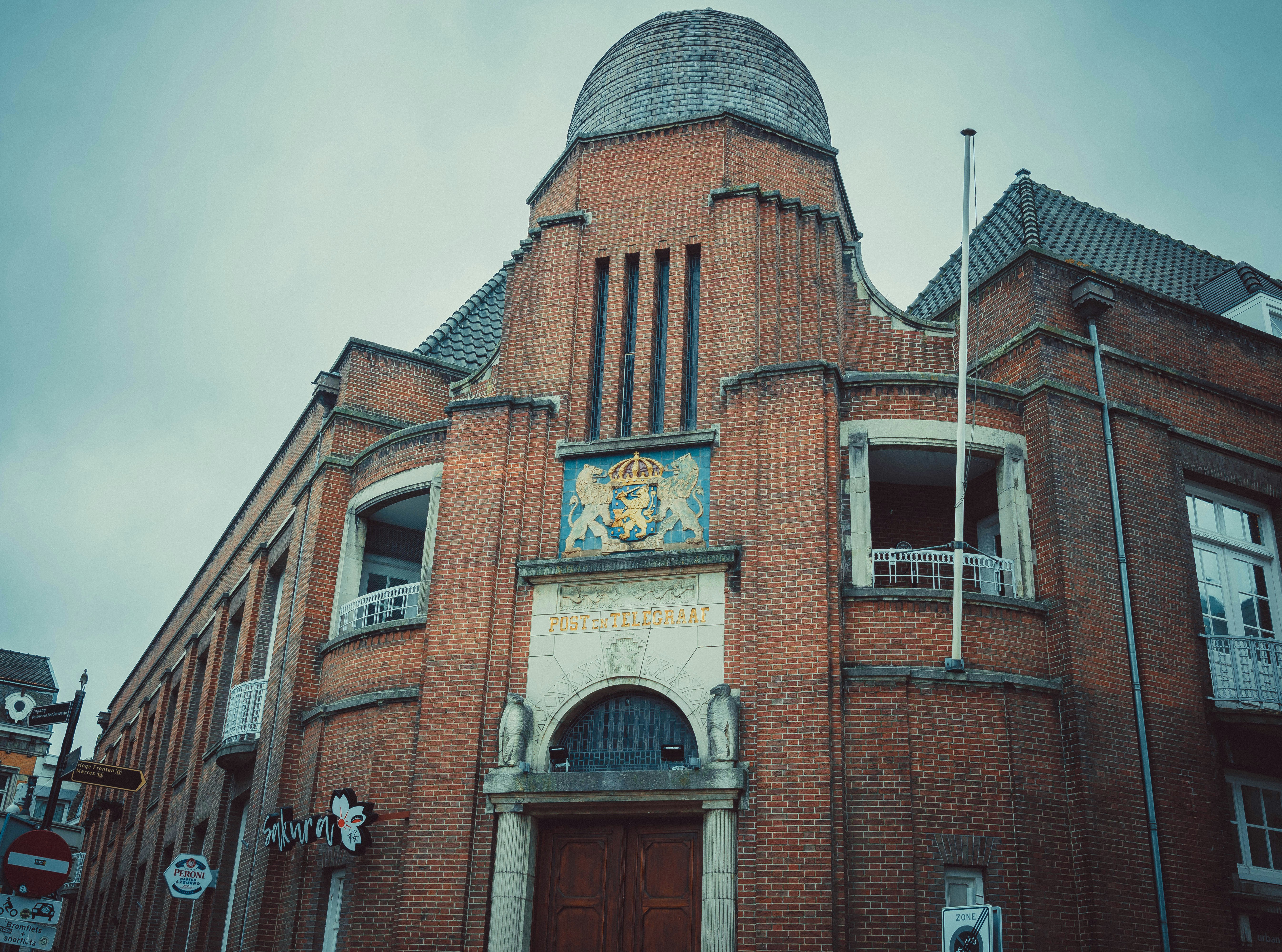 a large brick building with a clock on it's side