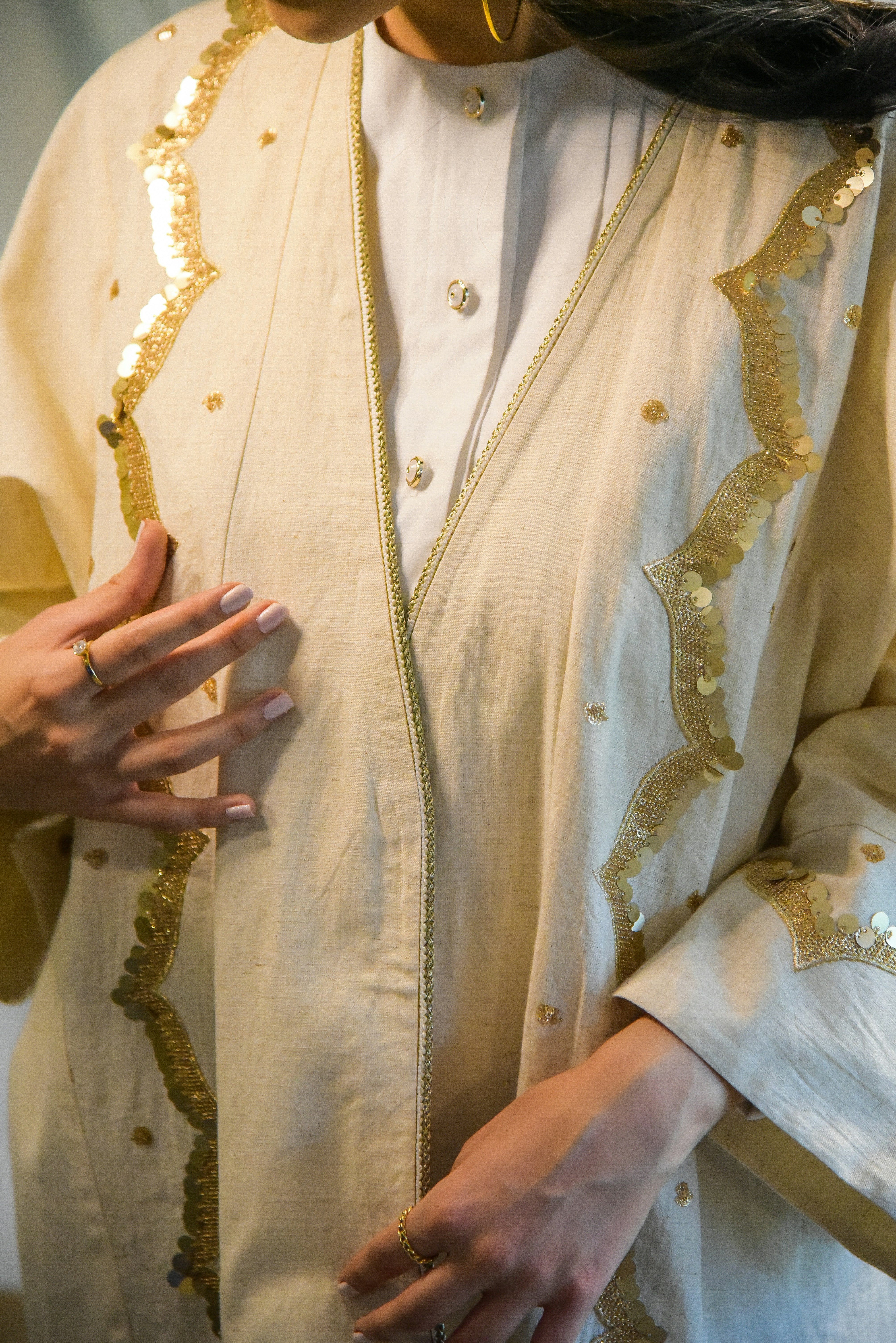 a woman wearing a white and gold outfit