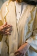 a woman wearing a white and gold outfit