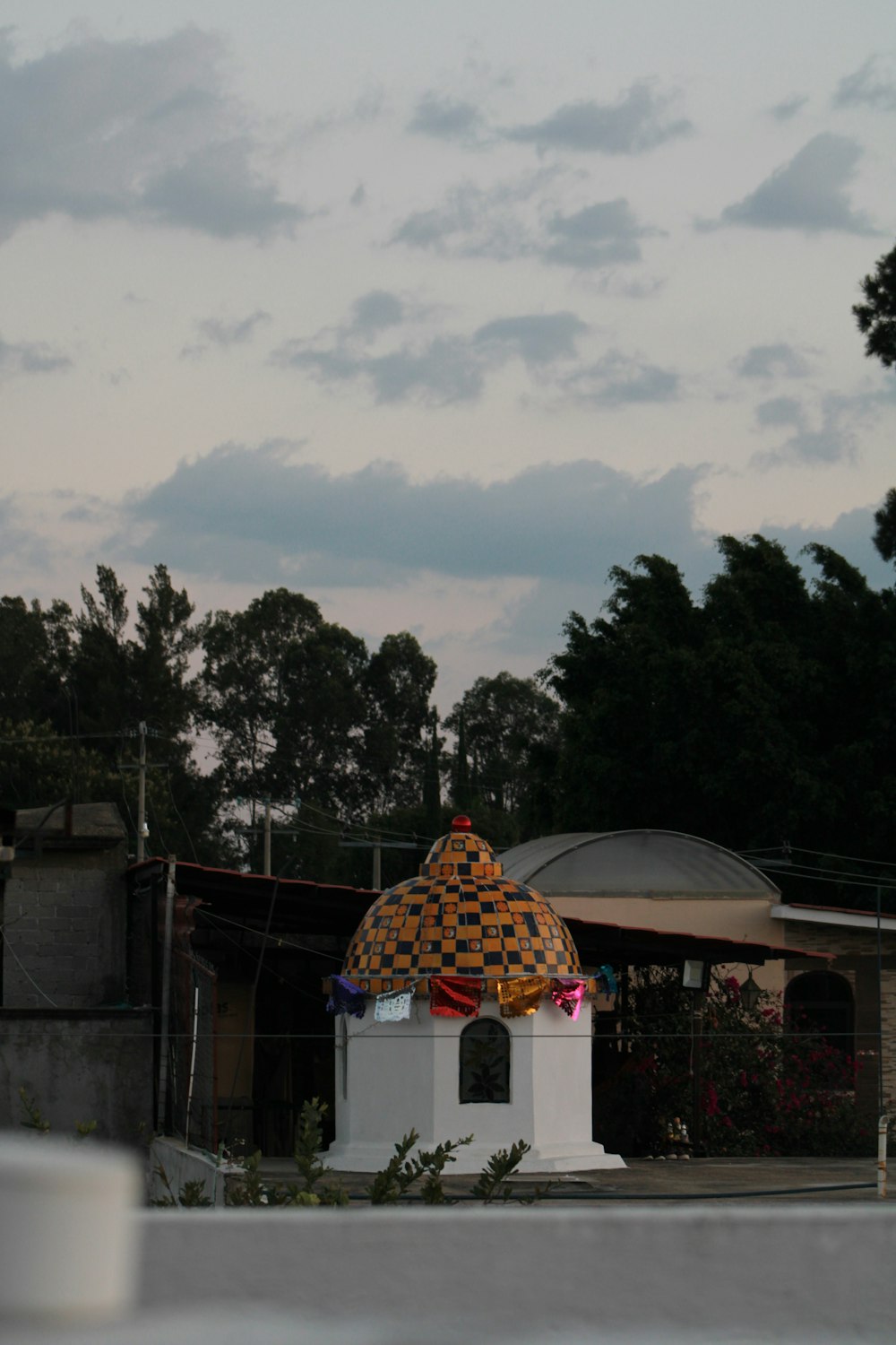 a white building with a yellow and black dome