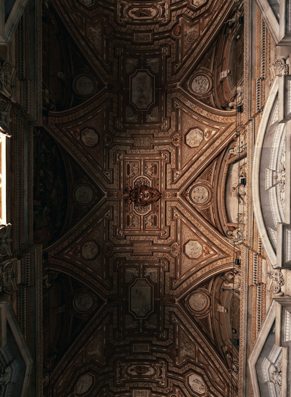 the ceiling of a church with a clock on it