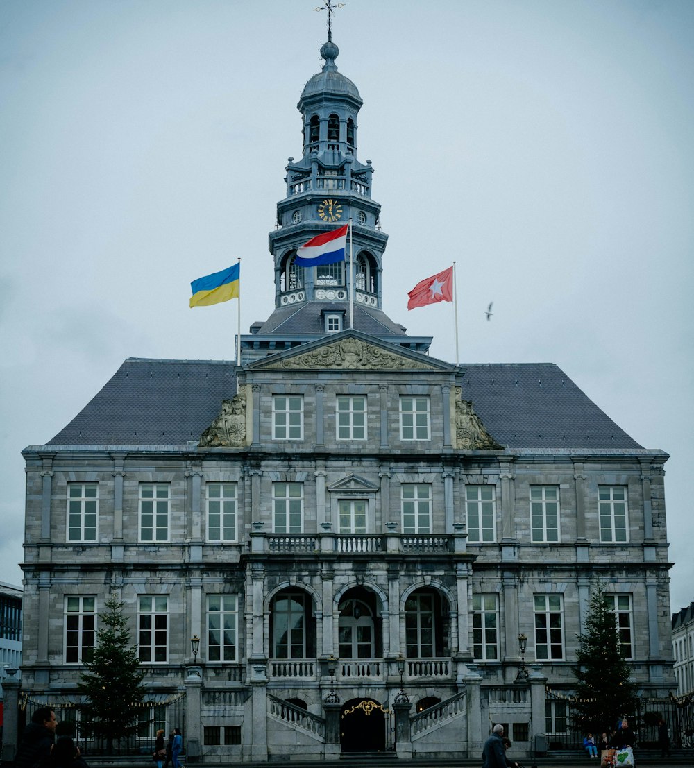 a large building with a tower and a flag on top of it