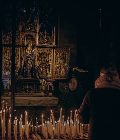 Devotees lighting candles in front of the temple altar.
