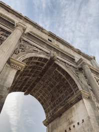 a large stone arch with a sky background