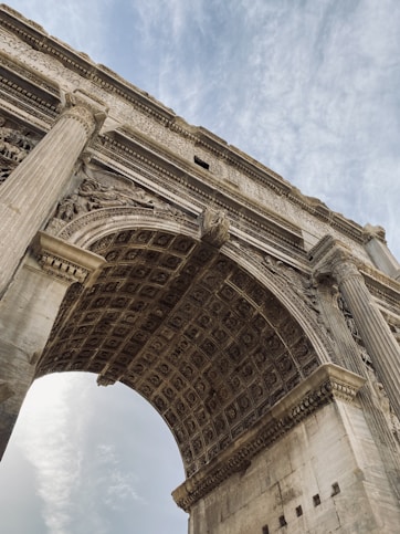 a large stone arch with a sky background