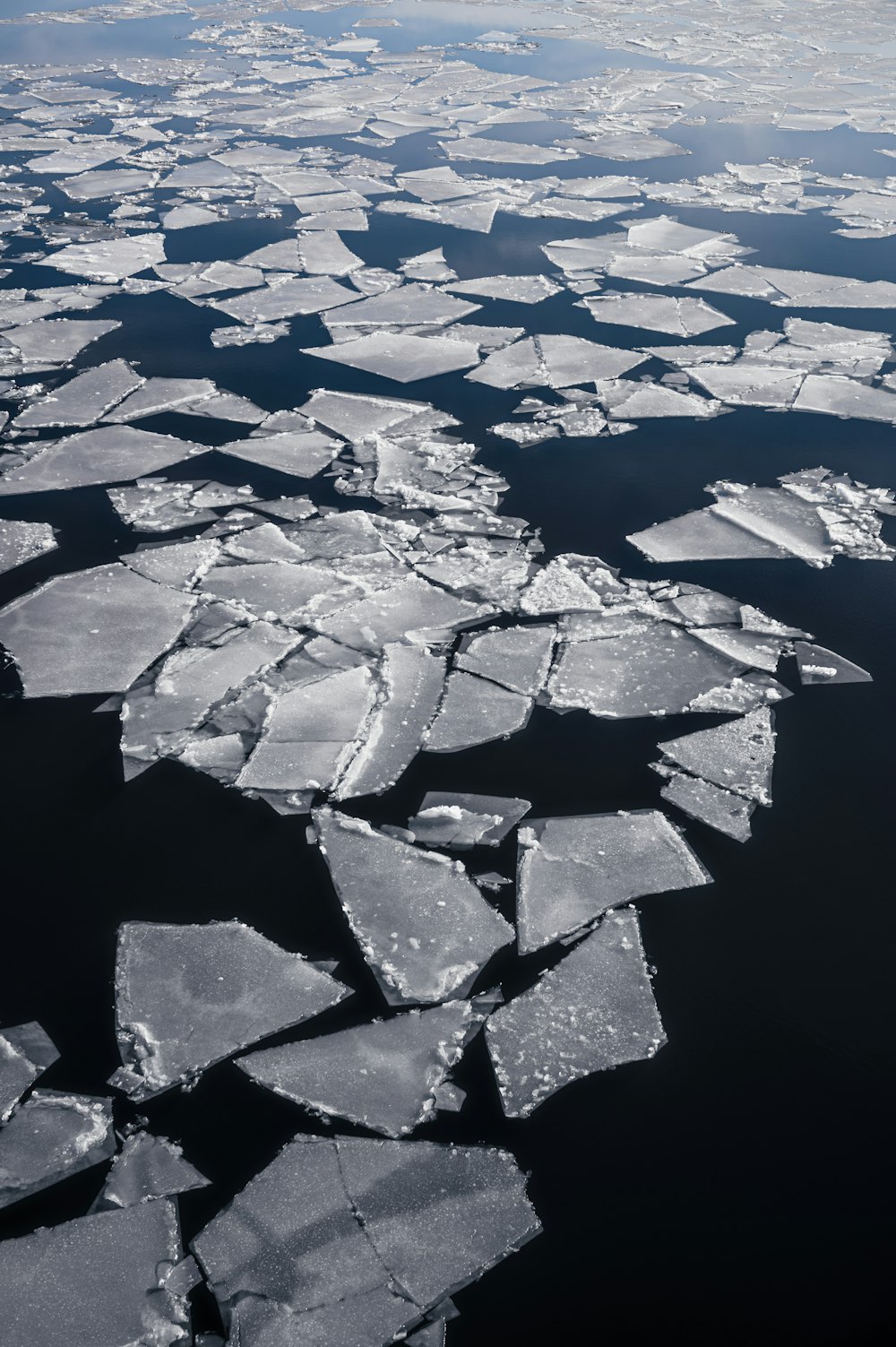 an aerial view of ice floes in the ocean