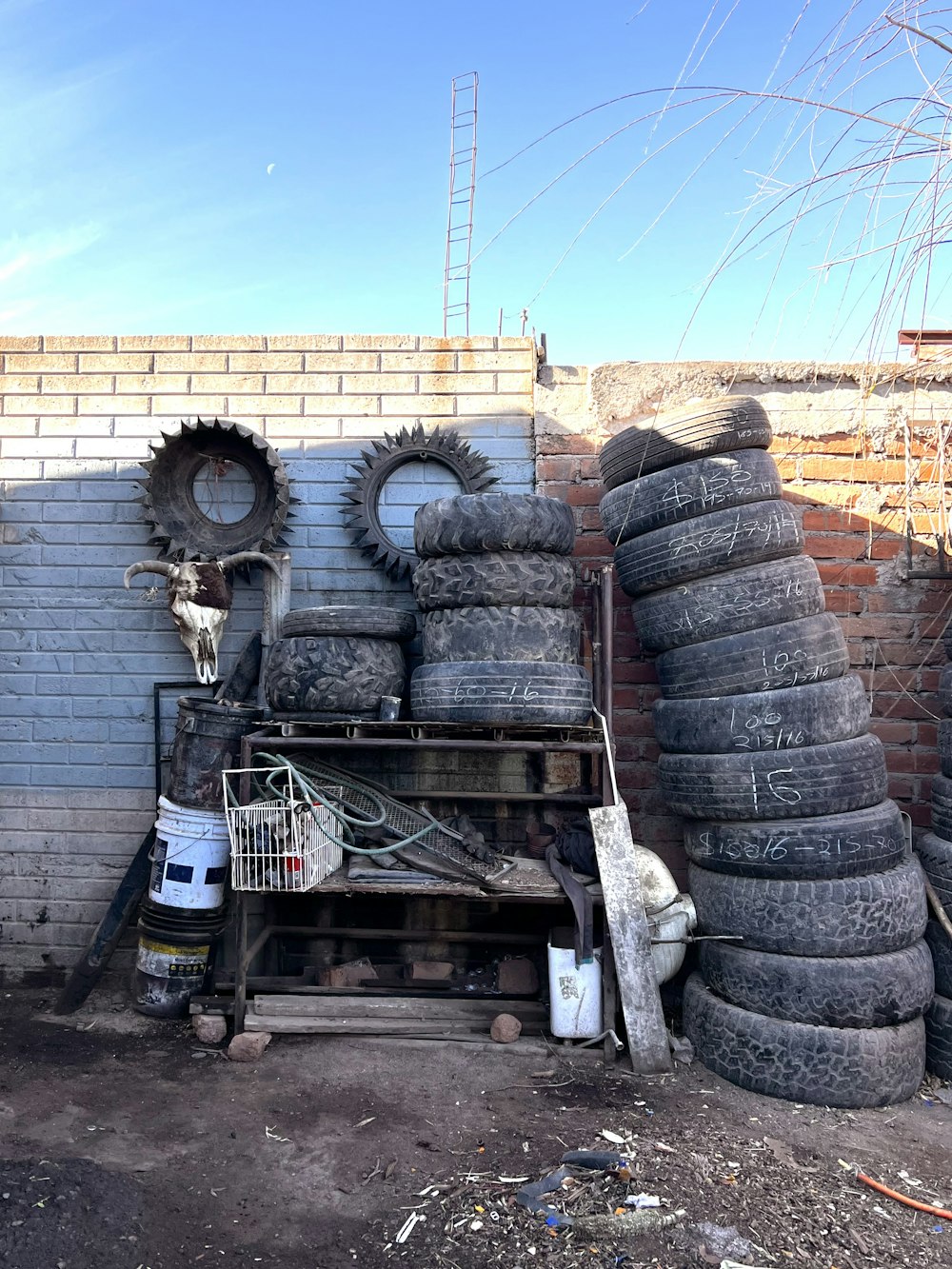 a pile of tires sitting next to a brick wall