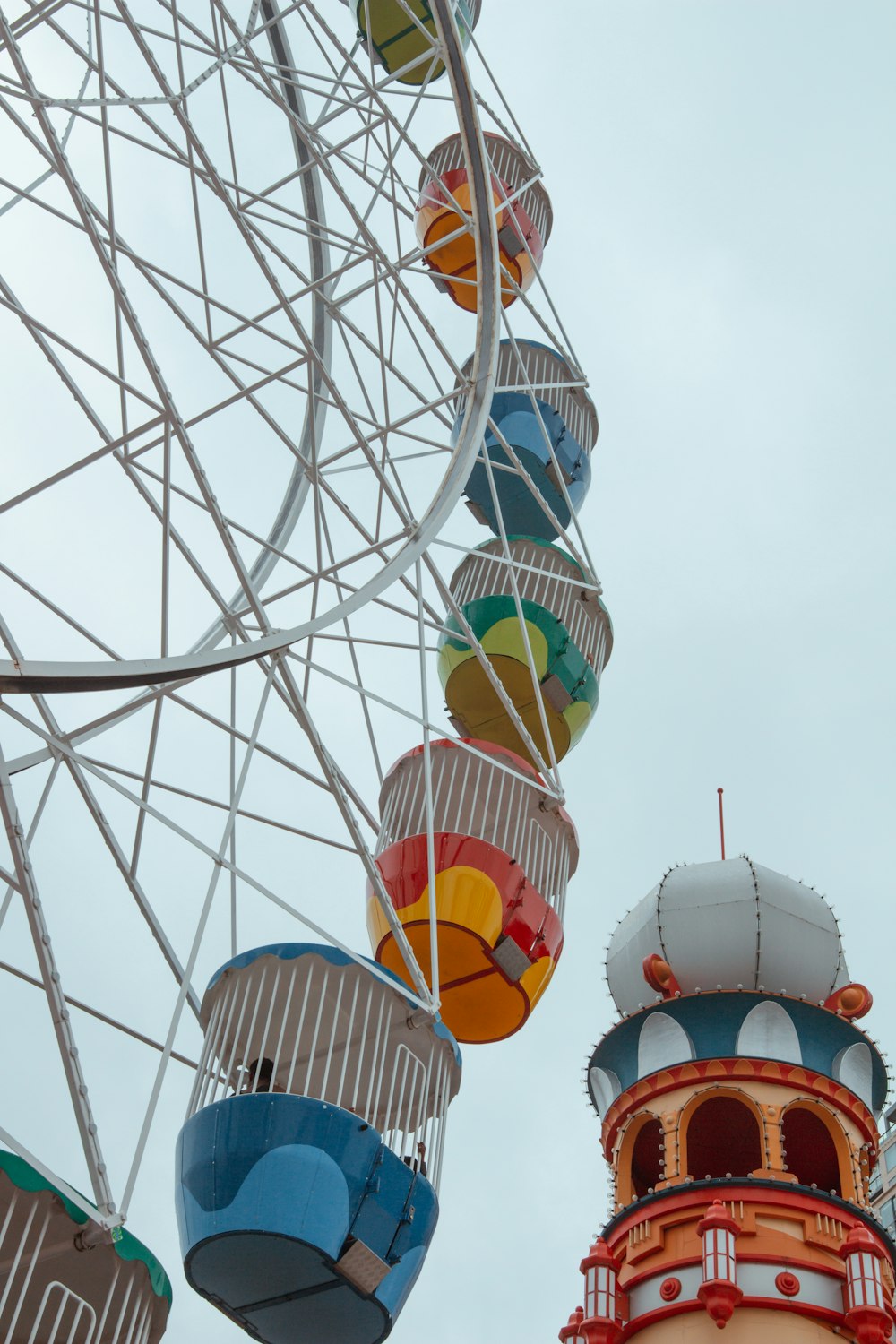 a ferris wheel and a building with a clock on it