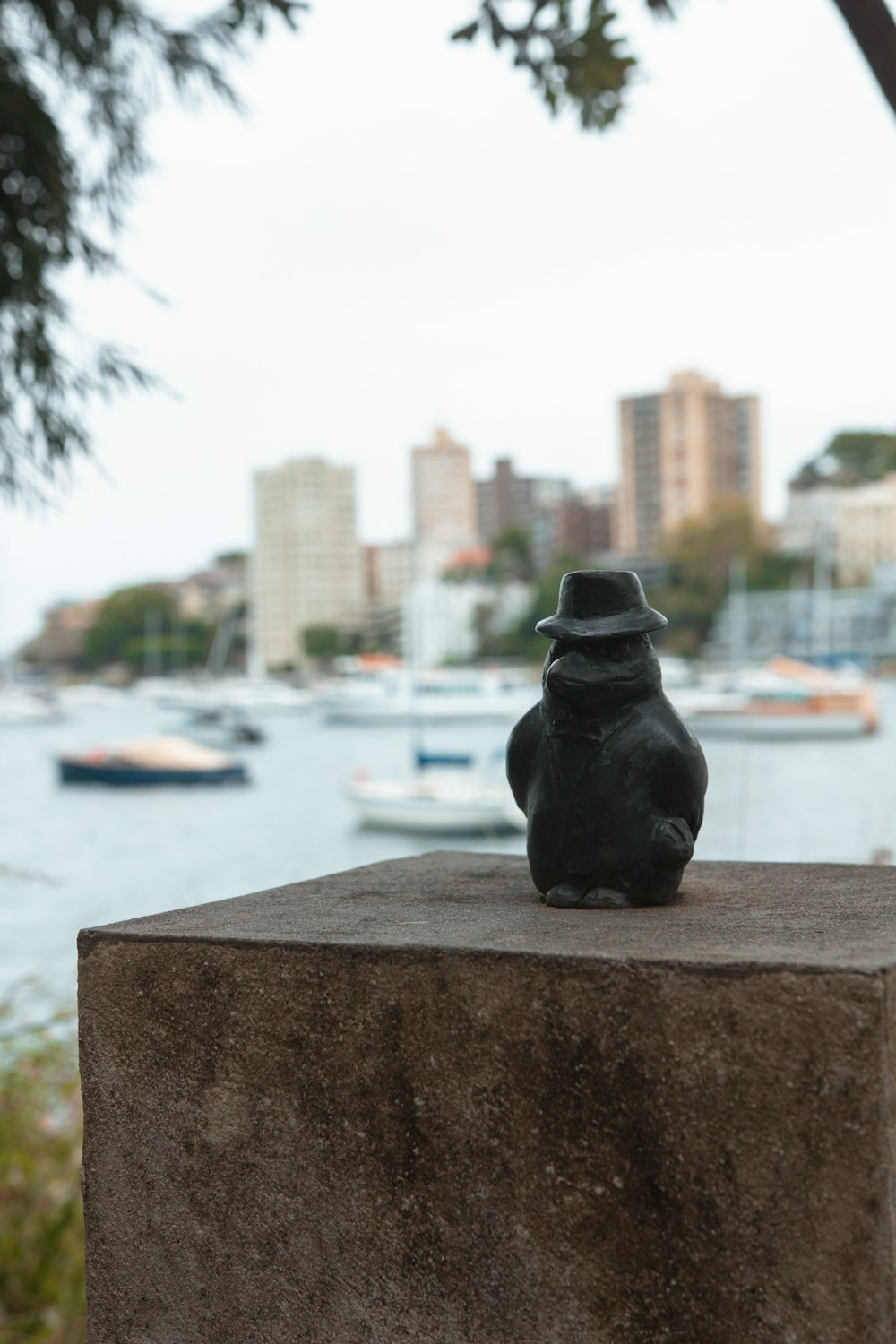 a statue of a bird sitting on top of a cement block