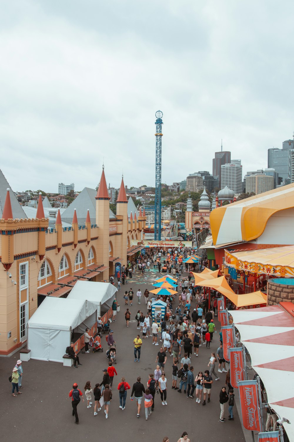 a crowd of people walking around a carnival