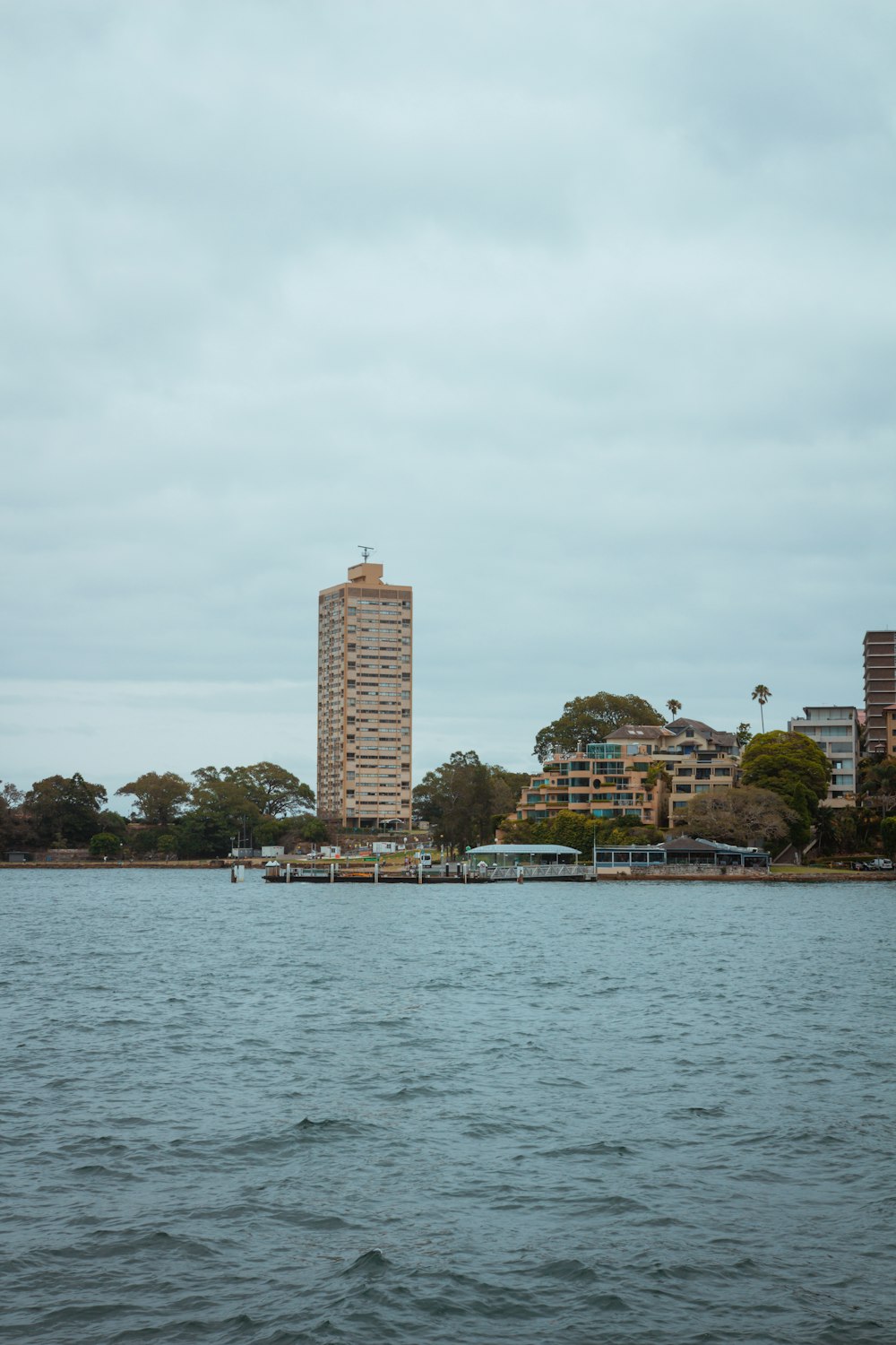 a large body of water with a tall building in the background