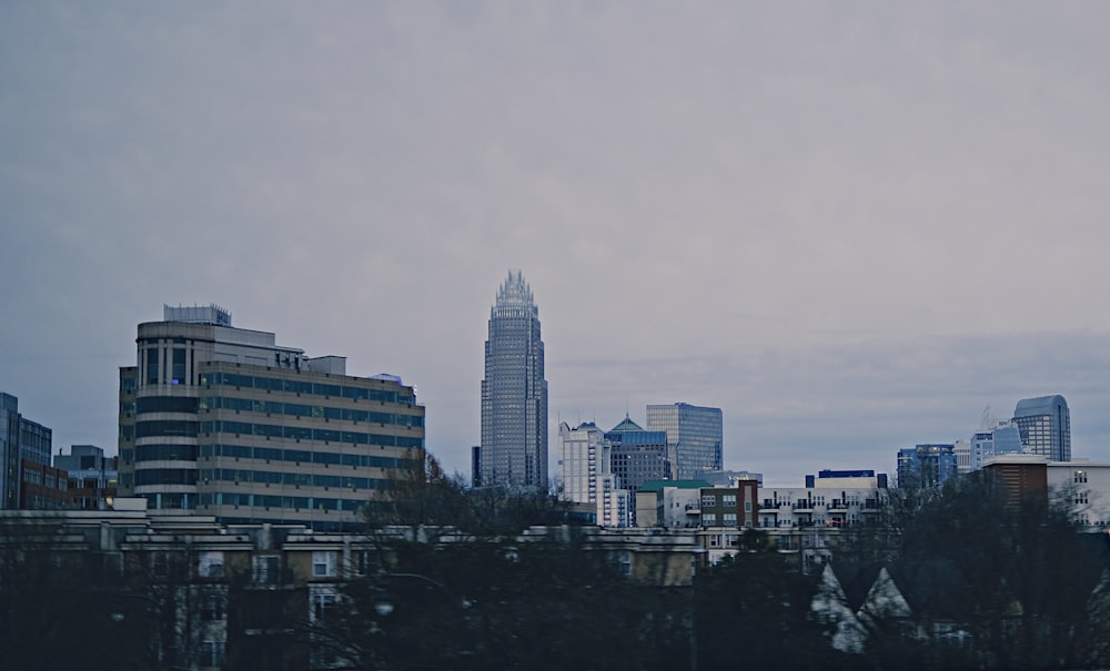 a plane flying over a city with tall buildings