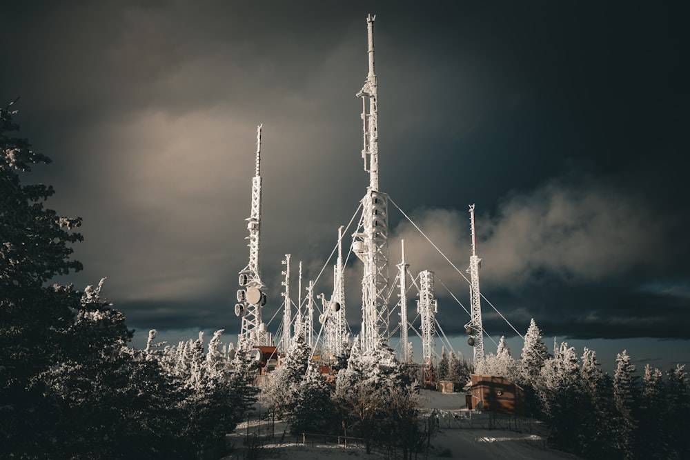 a very tall tower sitting in the middle of a forest