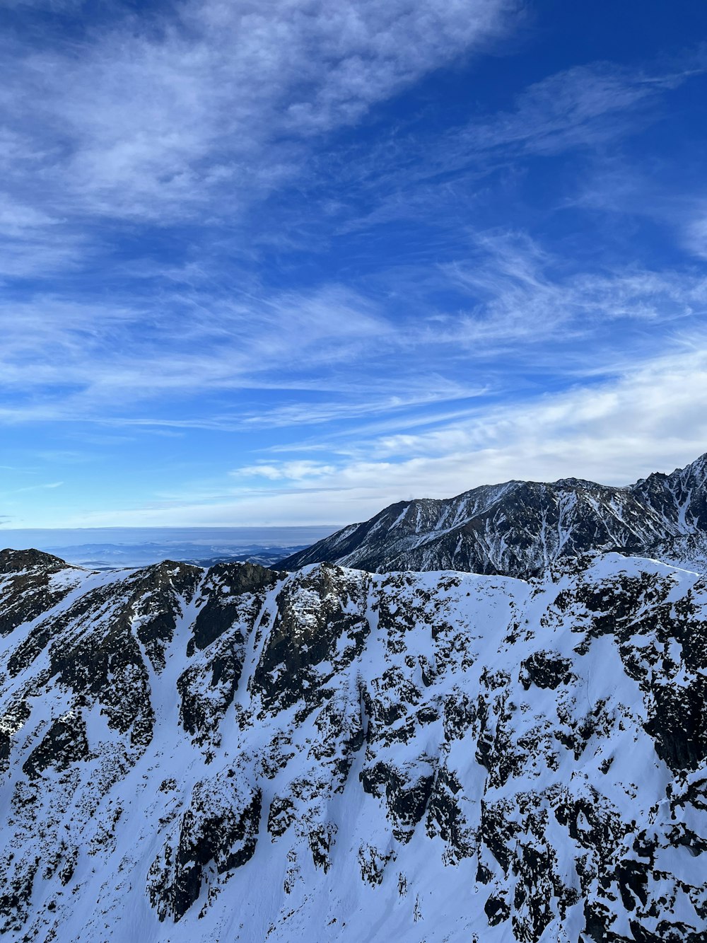 a view of a mountain range covered in snow