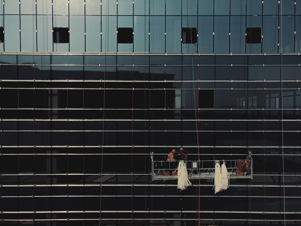 a couple of people standing on a balcony in front of a building