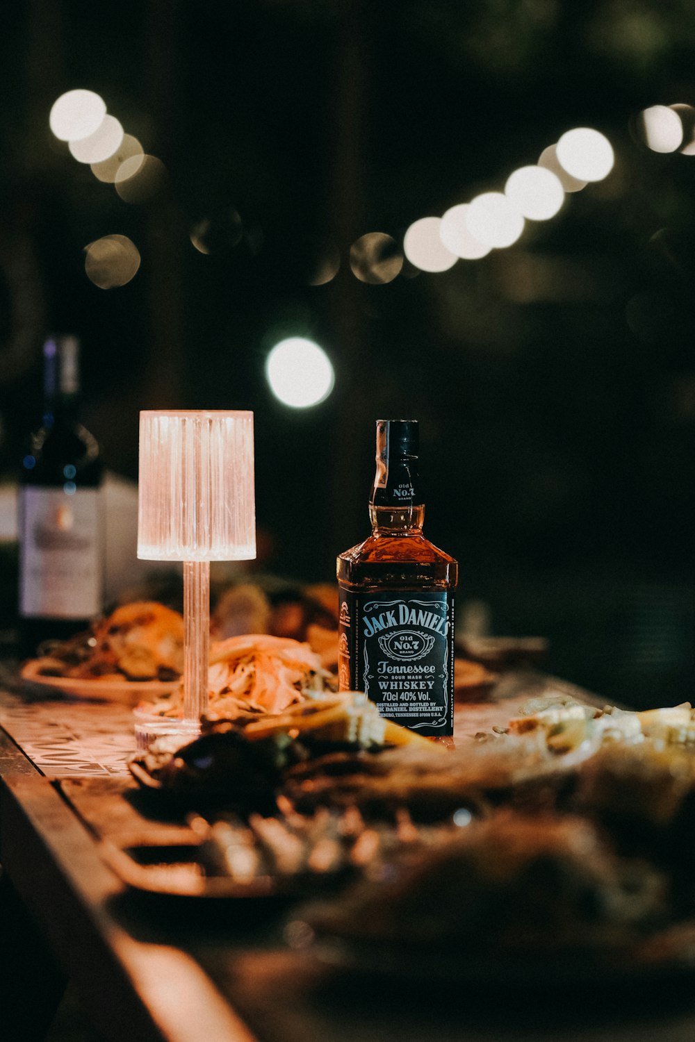 a bottle of beer sitting on top of a wooden table