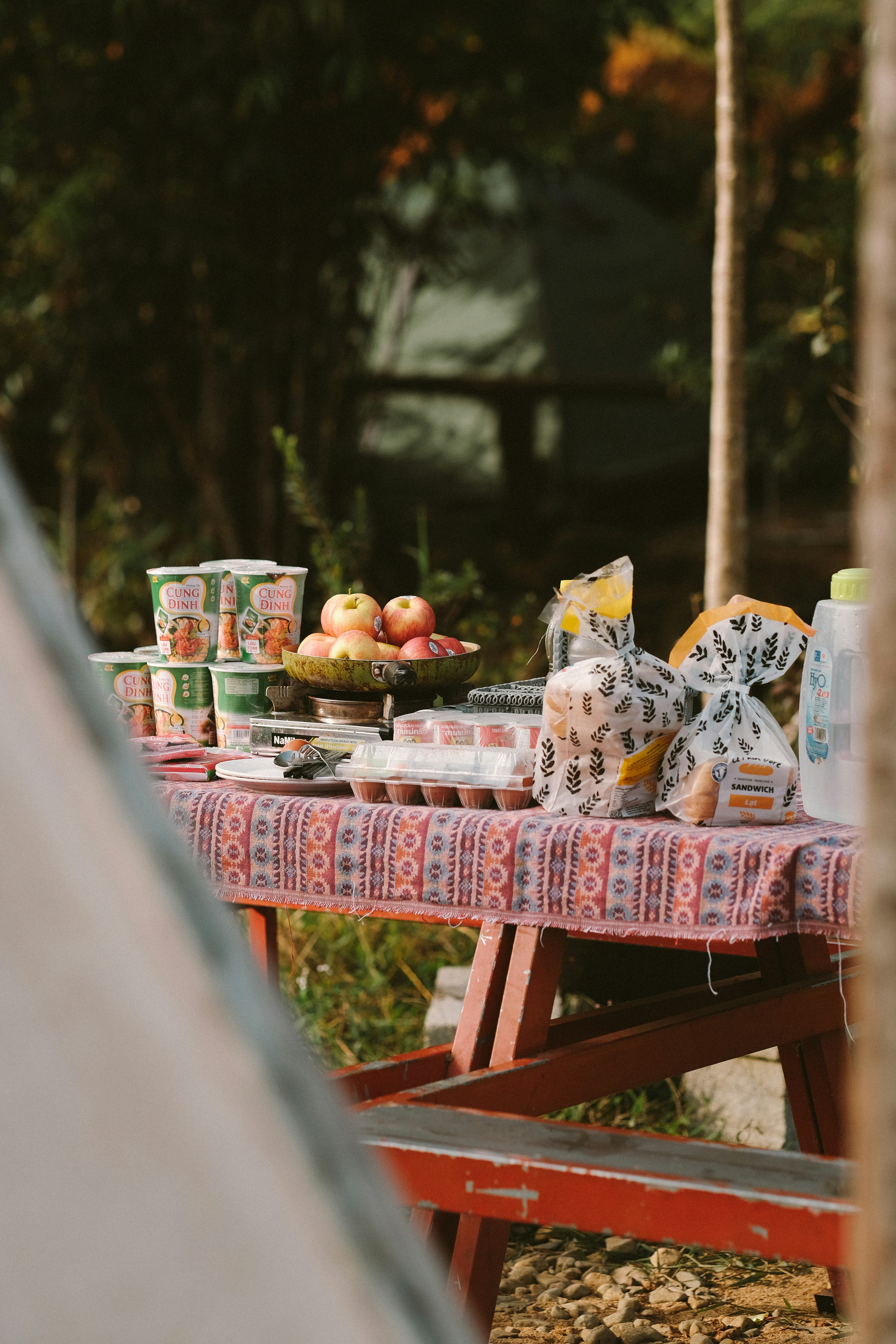 a picnic table with food and drinks on it