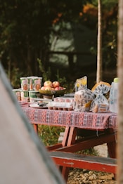 a picnic table with food and drinks on it