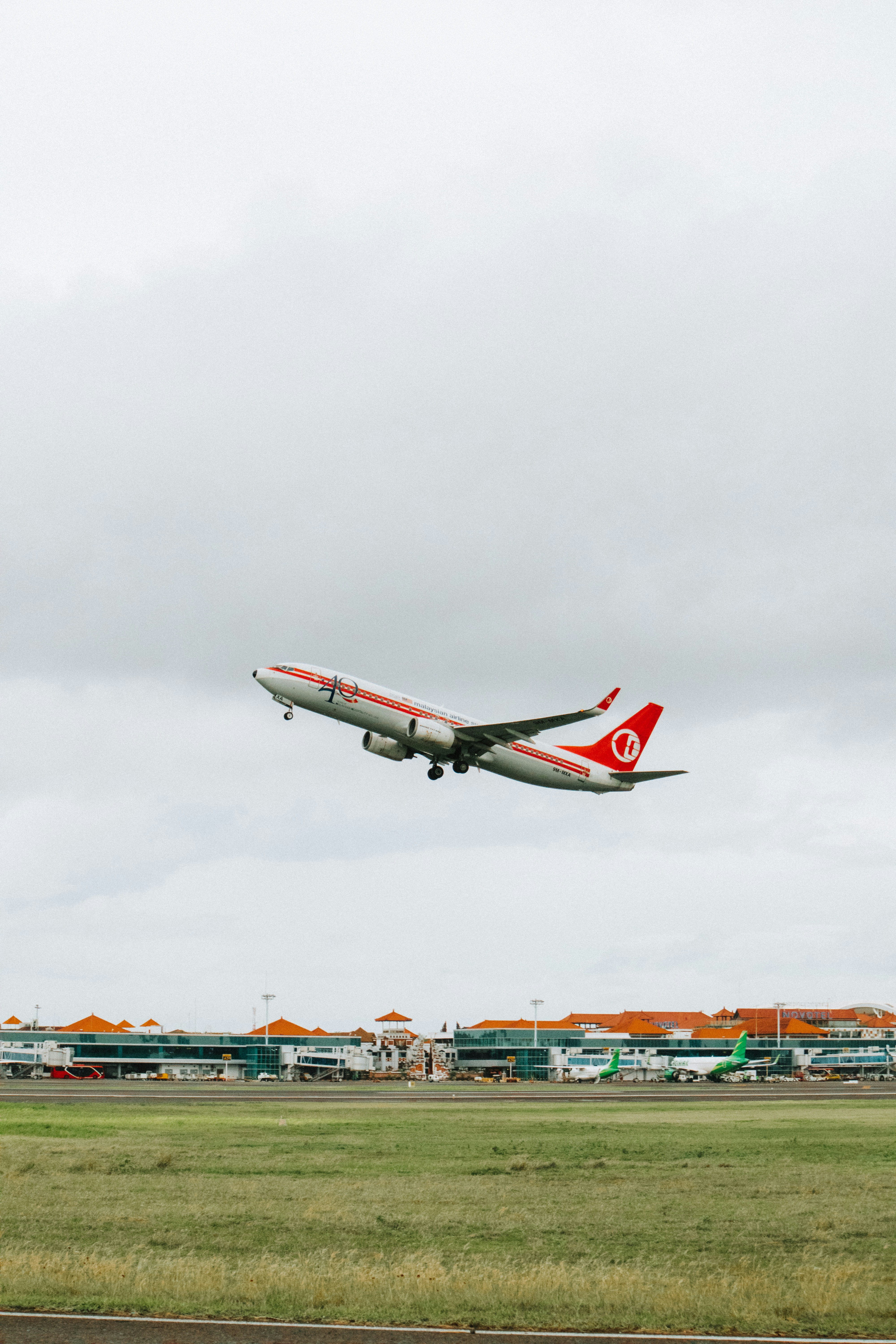 a large jetliner flying through a cloudy sky