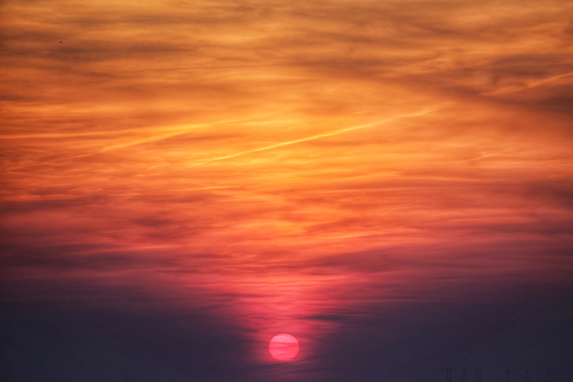 the sun is setting in the sky over the ocean