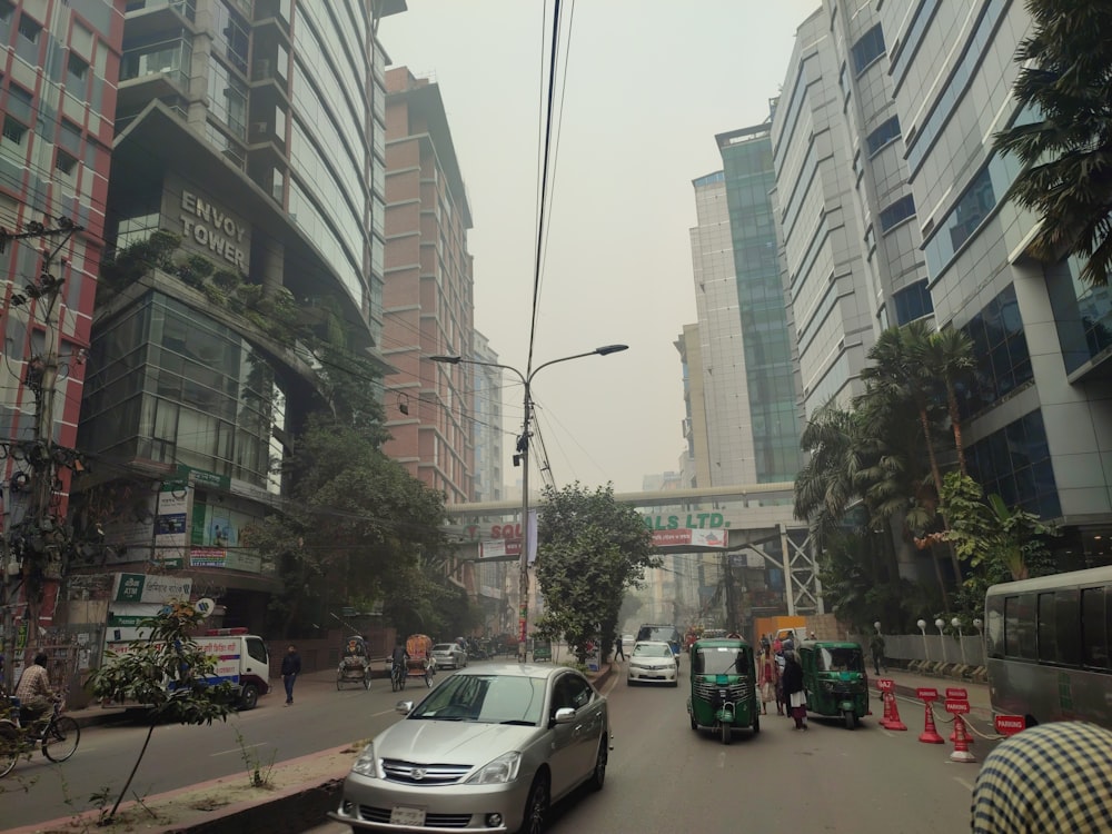 a car driving down a street next to tall buildings