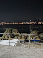 Event staff setting up an eye-catching display for a product launch under city lights.