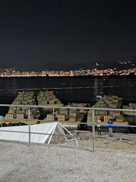 A dynamic shot of the Kelani Fire Works manufacturing floor with workers handling water gel explosives safely.