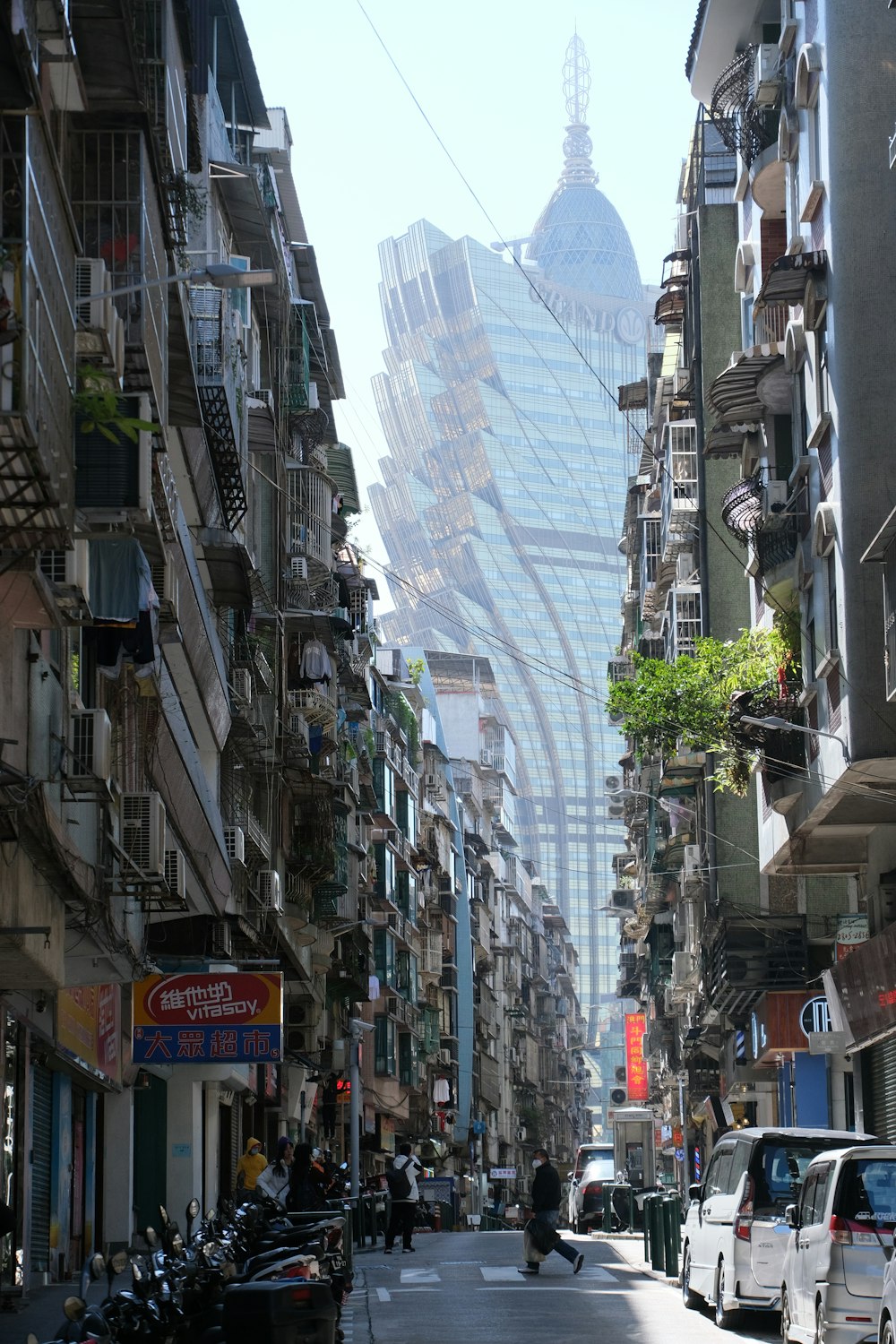 a city street lined with tall buildings and parked cars