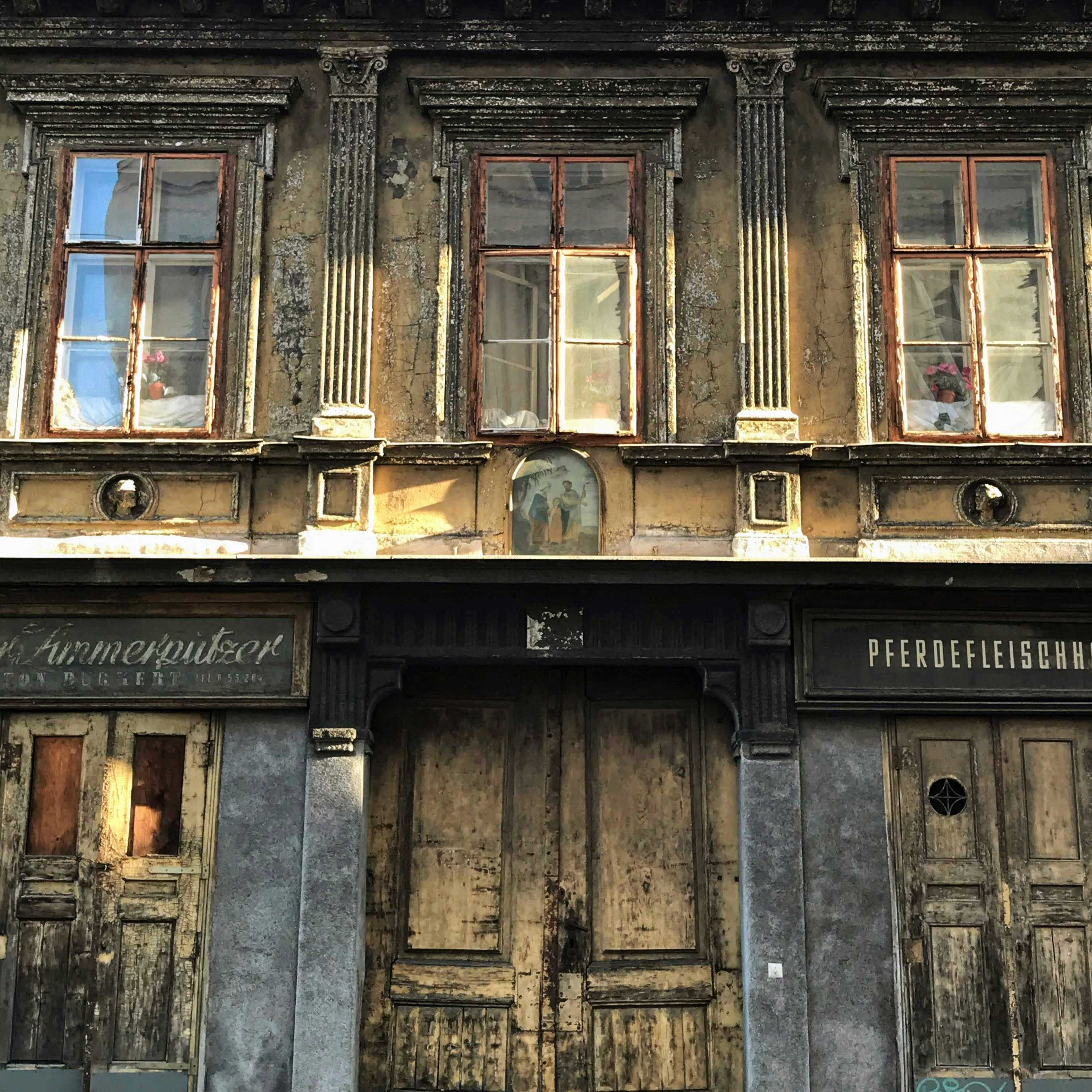 an old building with wooden doors and windows
