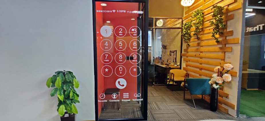 A close-up of a modern office phone with digital call data displayed on a screen.