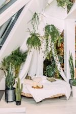 A cozy platform bed adorned with artificial plants for a fresh look.