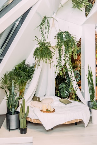 A cozy platform bed adorned with artificial plants for a fresh look.