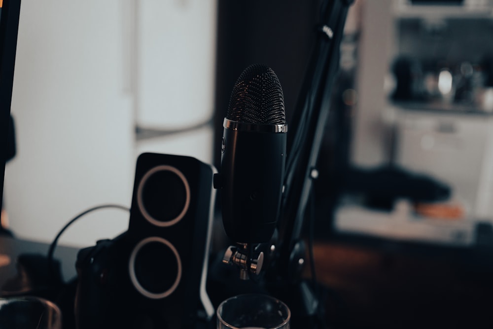 a microphone sitting on top of a table next to speakers