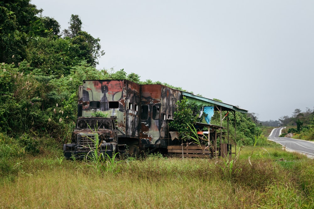 an old truck sitting on the side of the road