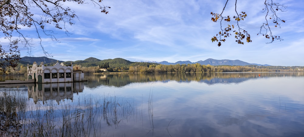 Un lac entouré d’arbres et de montagnes sous un ciel bleu