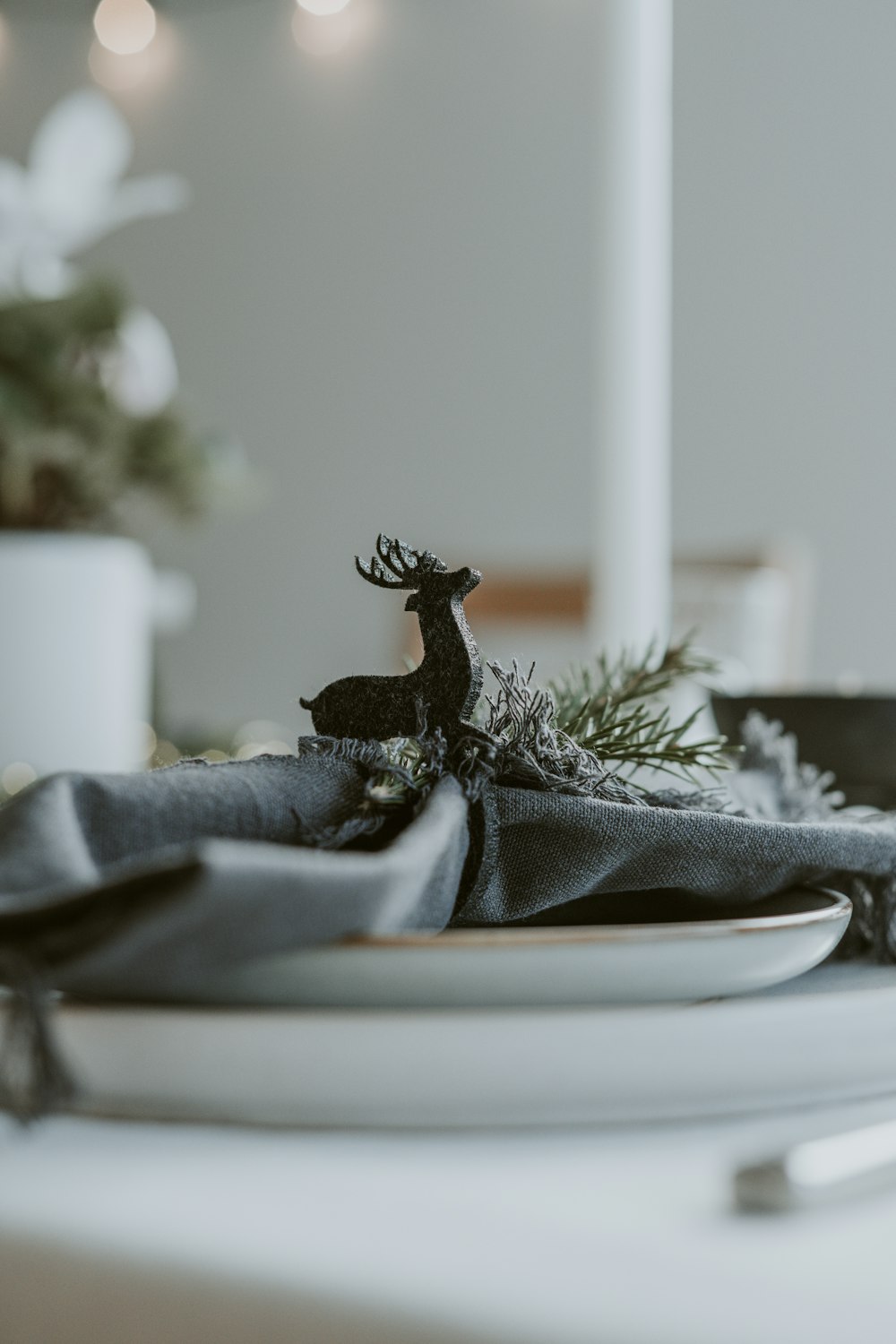 a white plate topped with a deer figurine