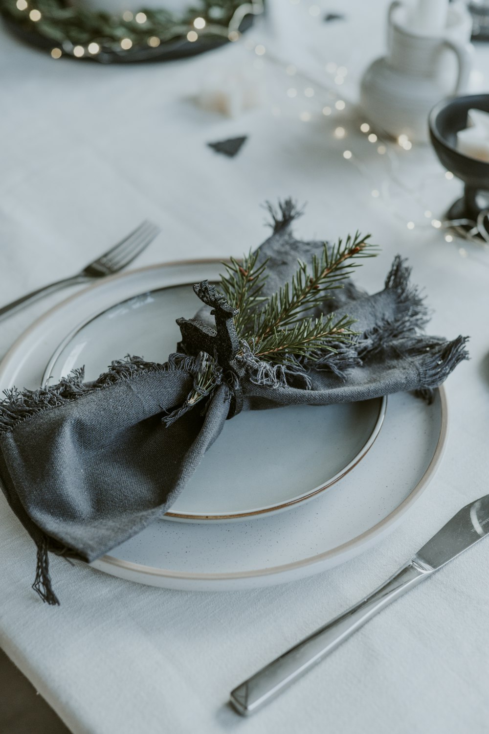 a place setting with silverware and napkins