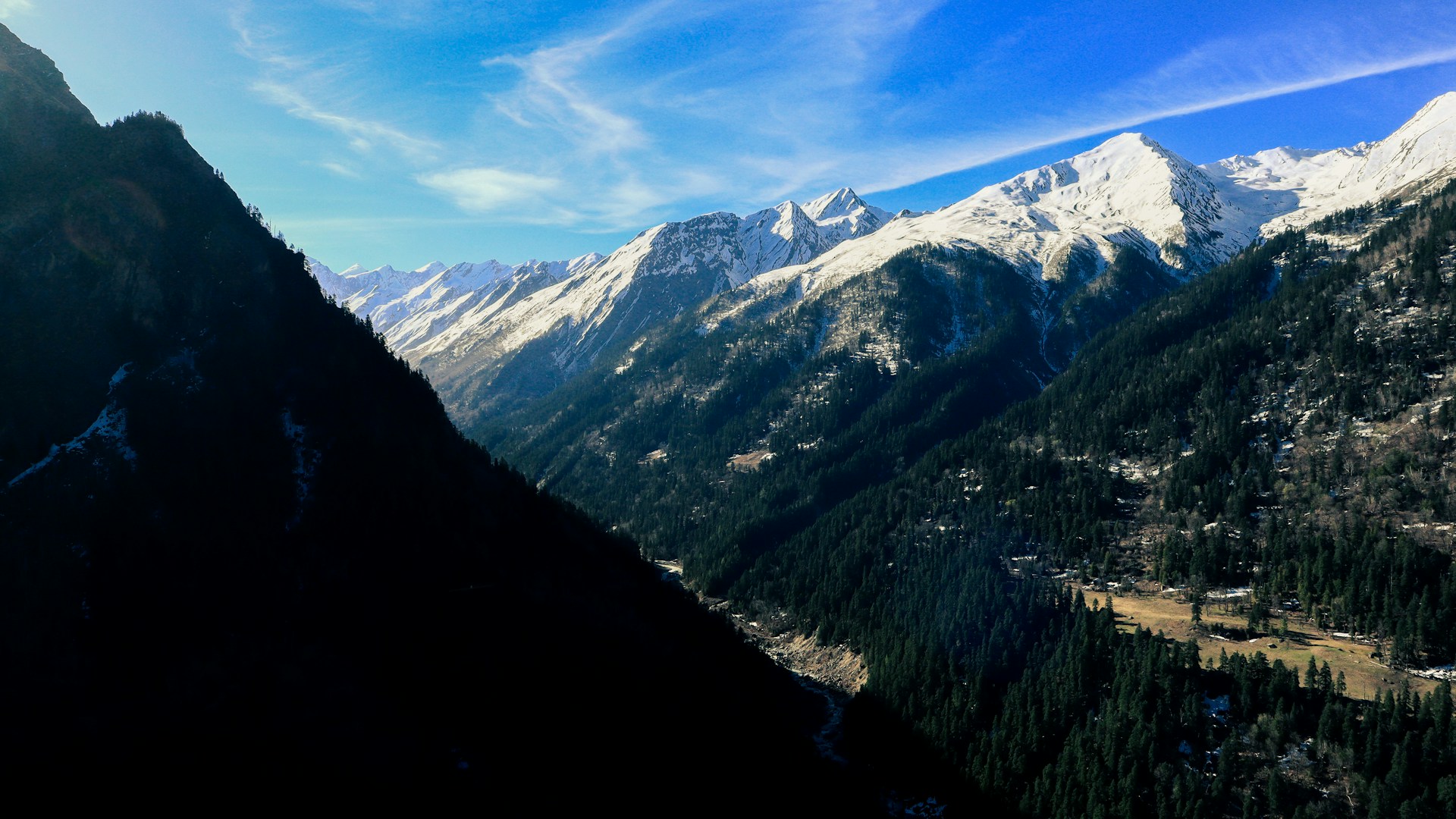 a view of a mountain range with snow on the mountains