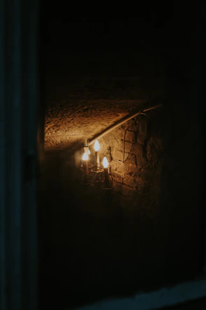 The rustic bar area featuring stone walls and vintage lanterns creating a warm atmosphere.