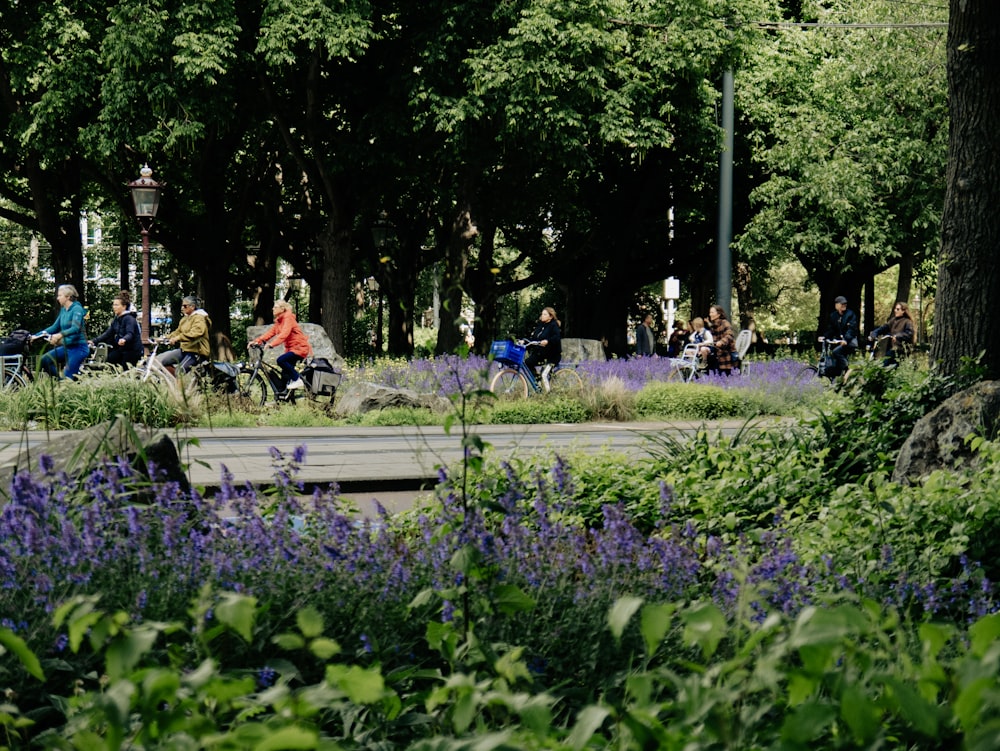 a group of people sitting on a bench in a park