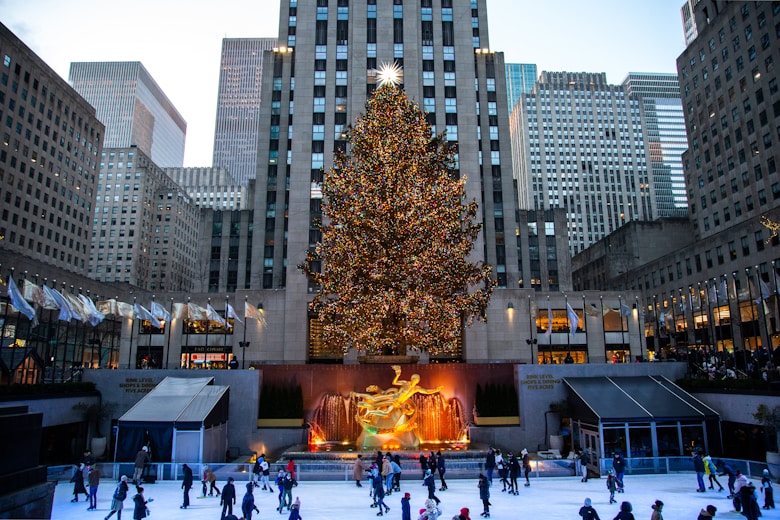 a large christmas tree in a city square New York