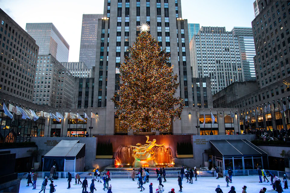 The illuminated Rockefeller Center Christmas tree framed by surrounding towers