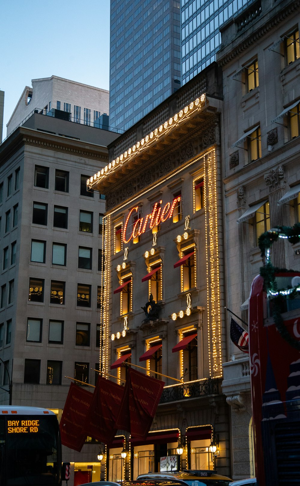 a very tall building with a lit up sign on it's side