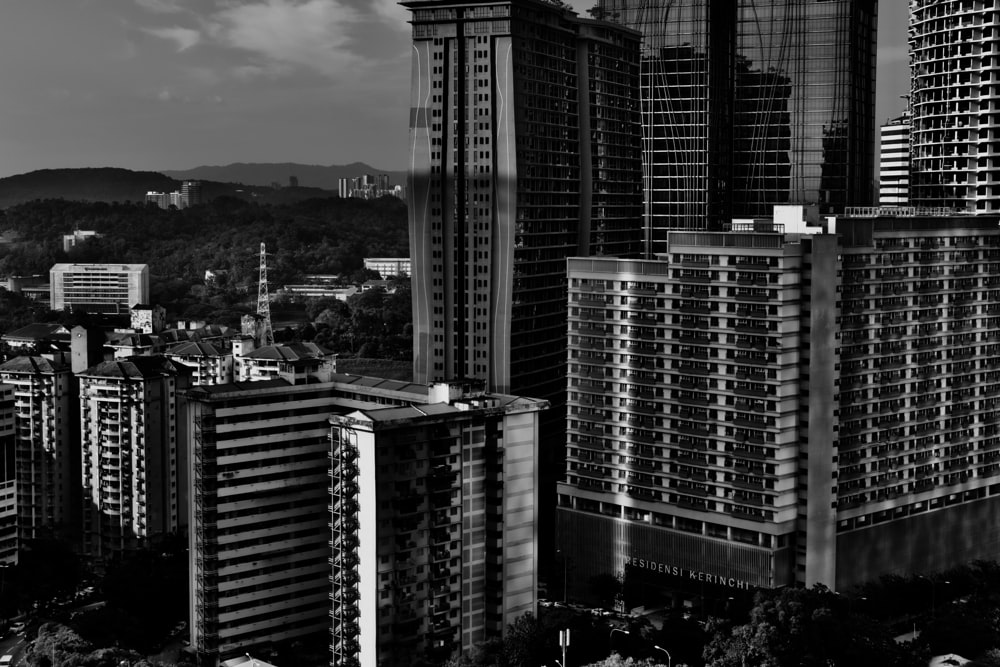 a black and white photo of tall buildings