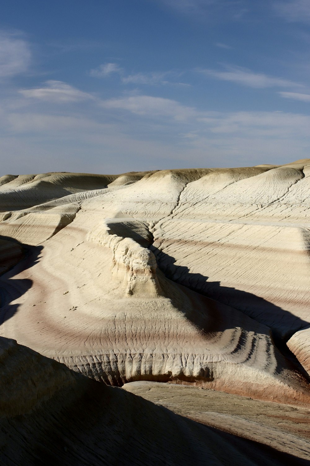 a view of a desert with a blue sky in the background