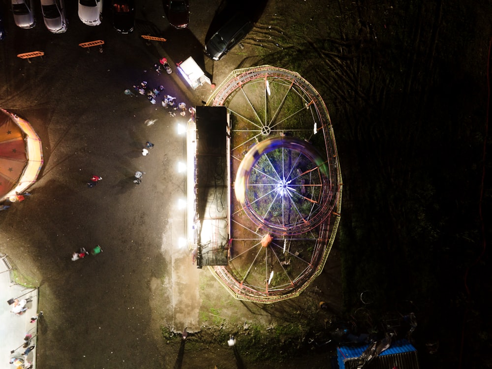 an aerial view of an amusement park at night